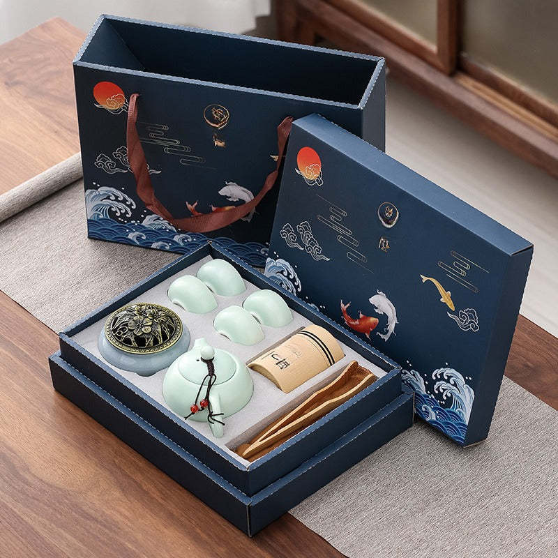 Tea set with decorative packaging on a wooden surface
