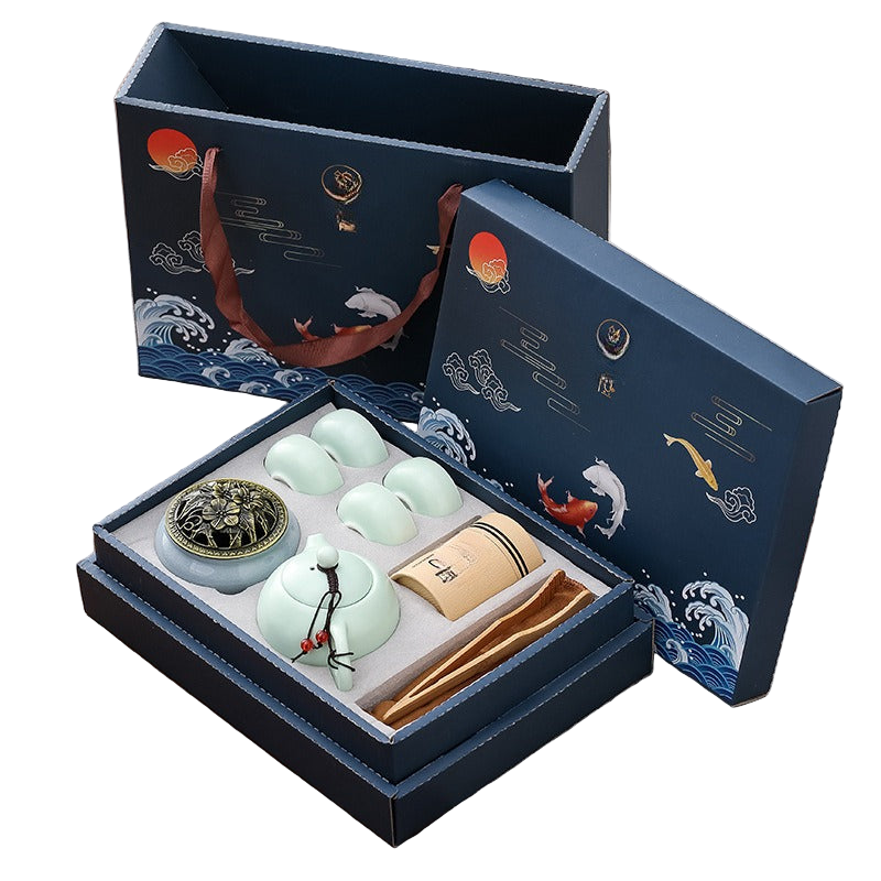 Tea set with decorative packaging featuring koi fish and wave designs.